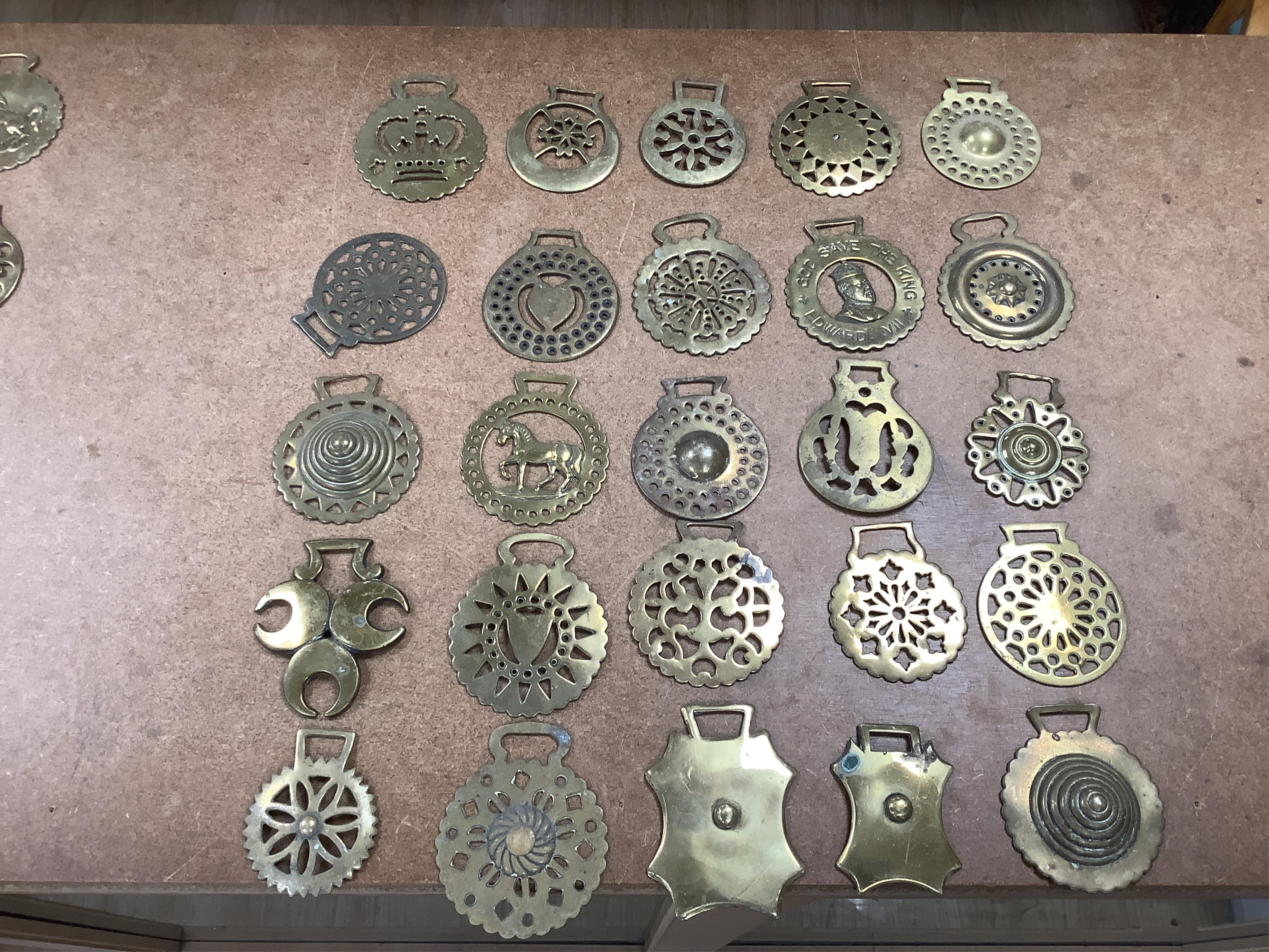 A collection of various horse brasses